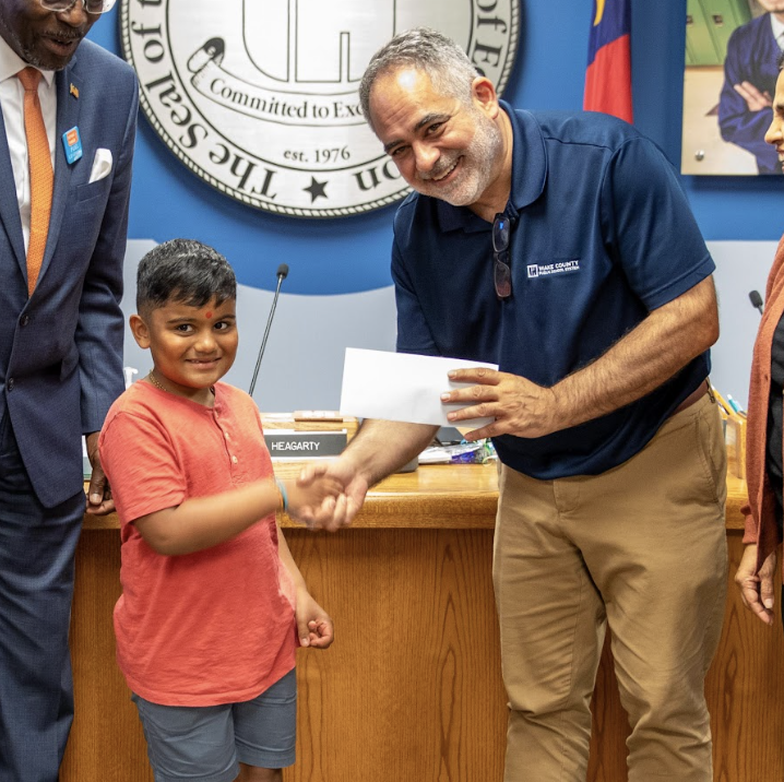  Board Chair with student and donation check