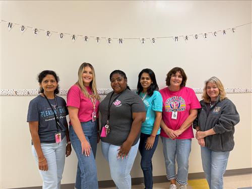 Kindergarten classroom teachers and instructional assistants in educator-themed attire