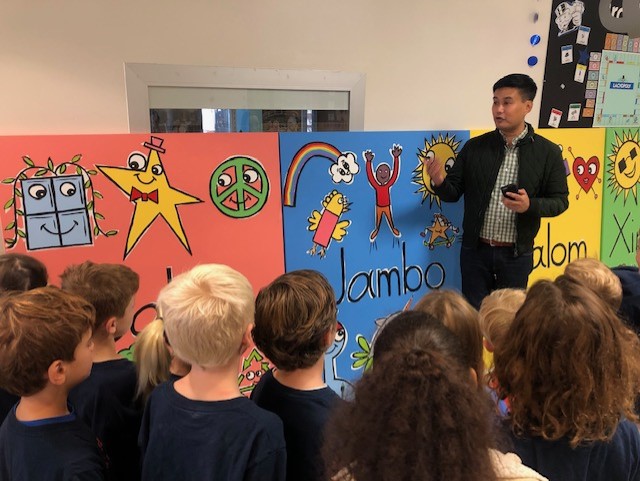 Bren Bataclan showing students his paintings