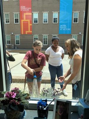 Students watering plants. 