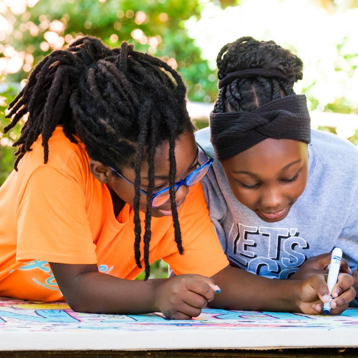  Students smiling while collaborating on a project