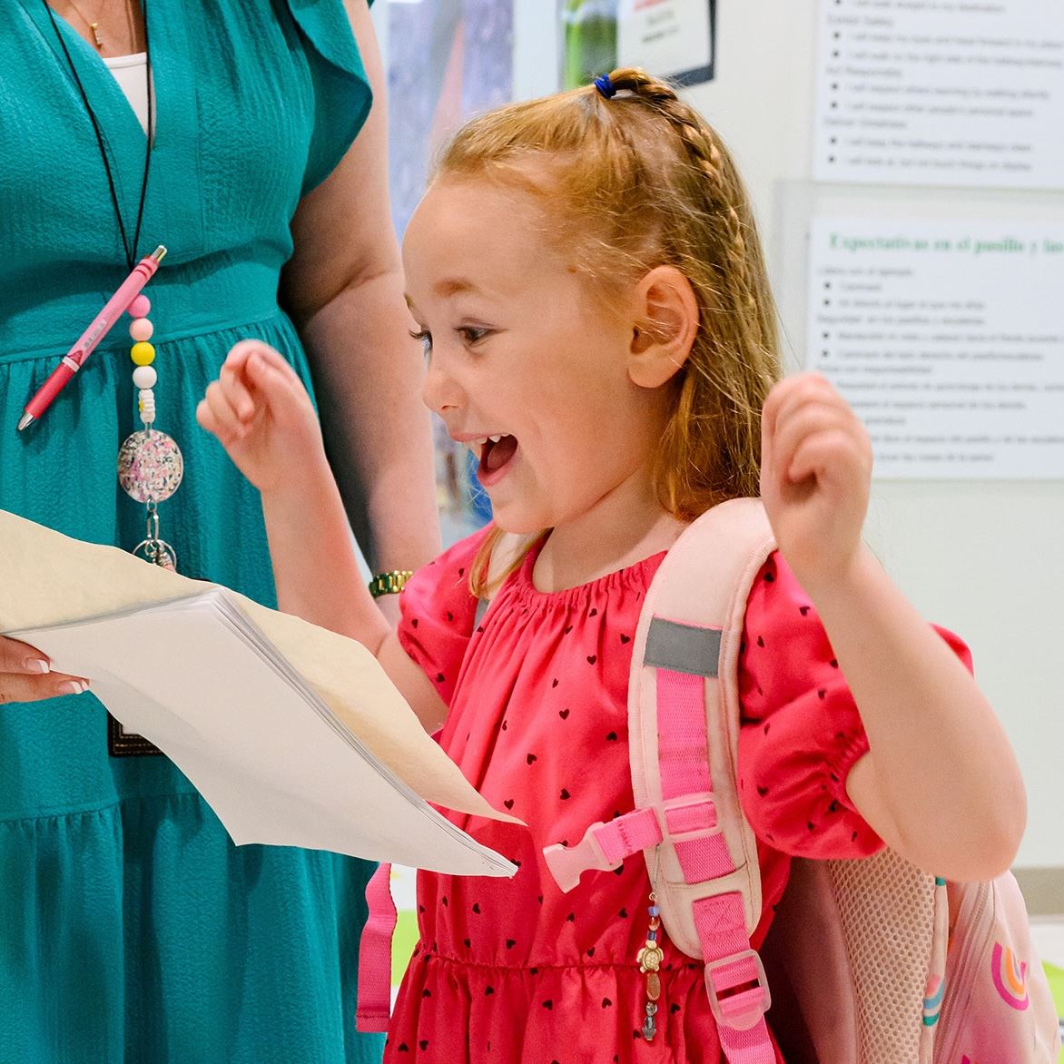  A student waves her arms in excitement