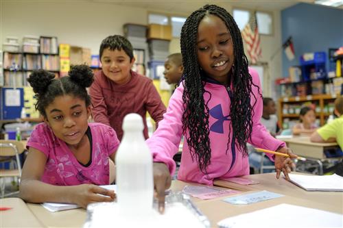 Photo of students doing a science activity.