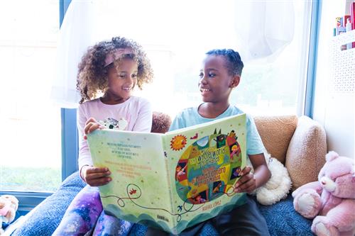 two students reading a book