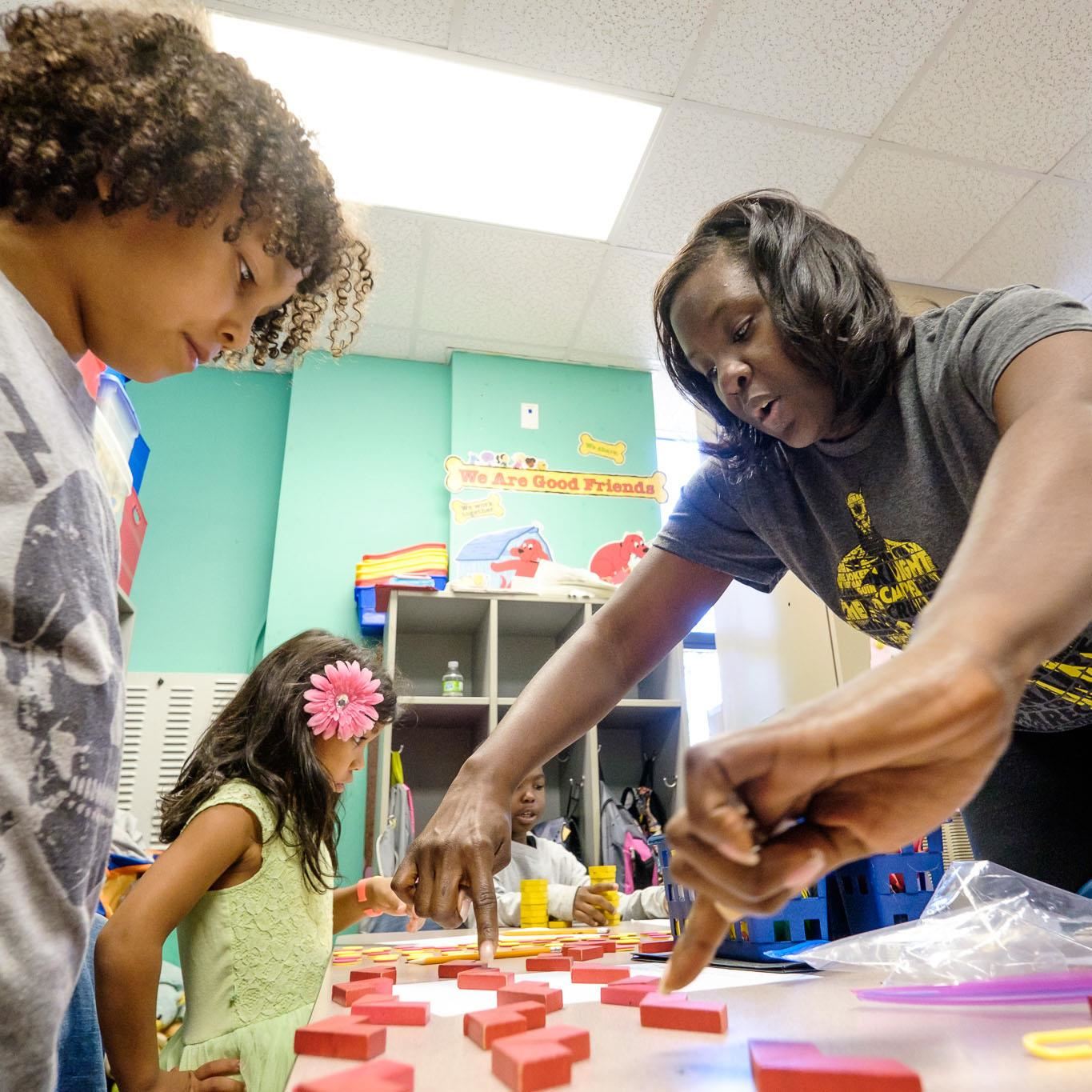 Volunteer working with students.