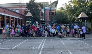 Group photo of dads and kids on the PME playground