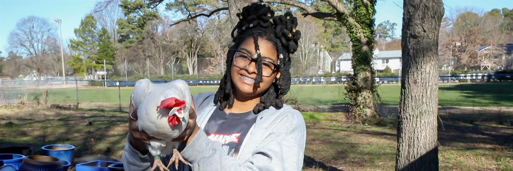 Smiling student with chicken