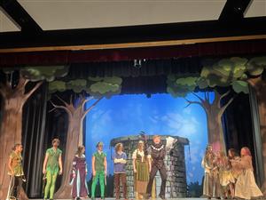 A group of actors with one exuberant student in the middle