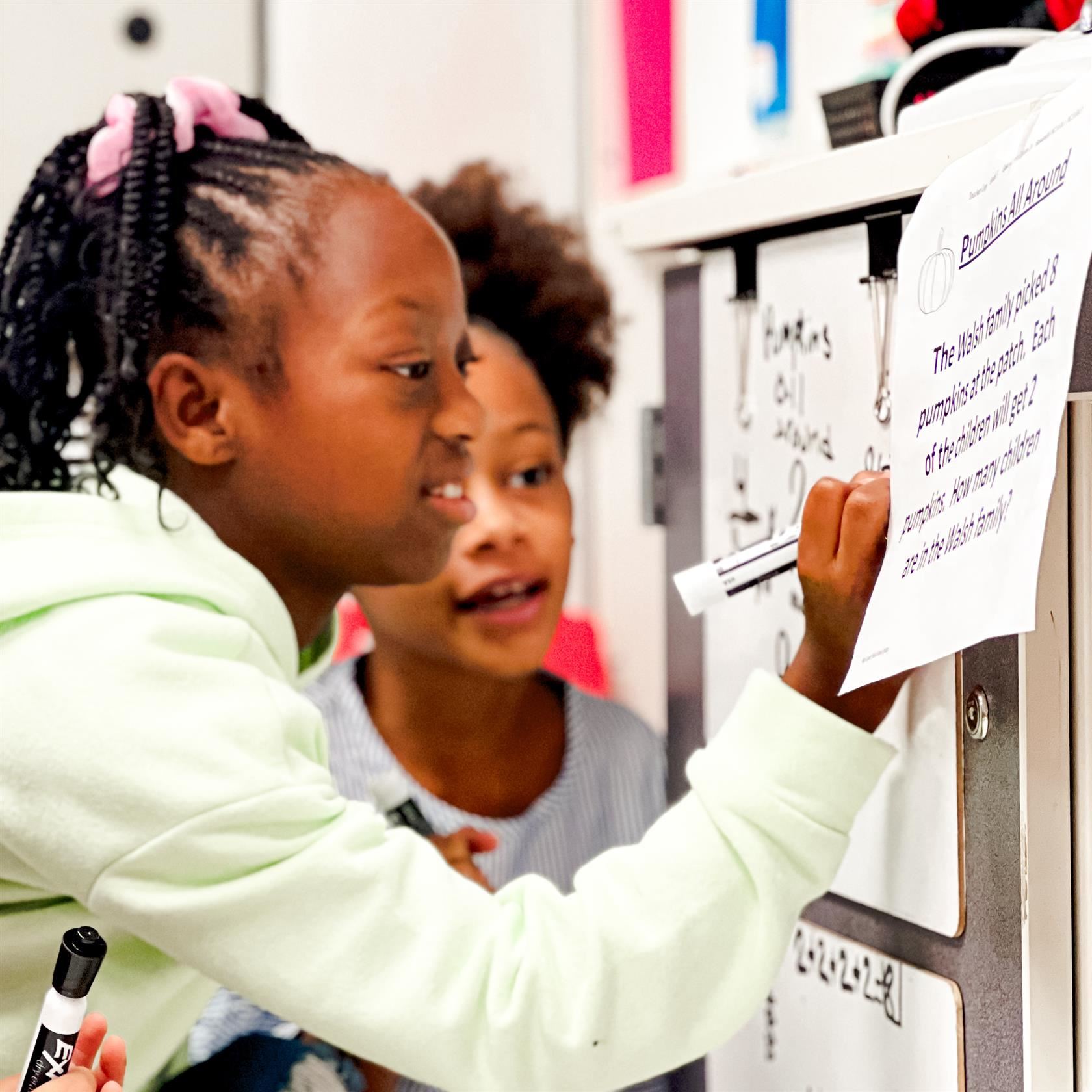  A student writes on a piece of paper