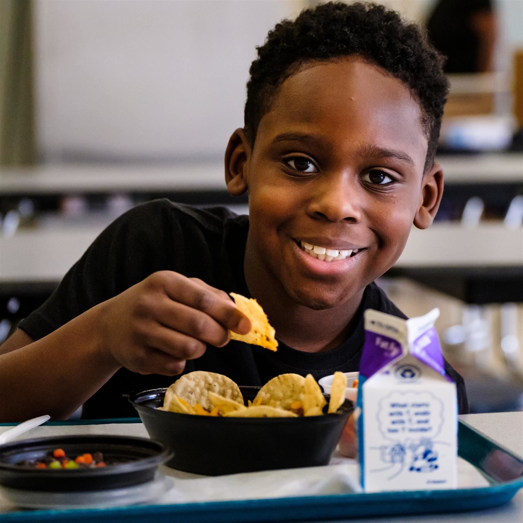  student eating breakfast nachos