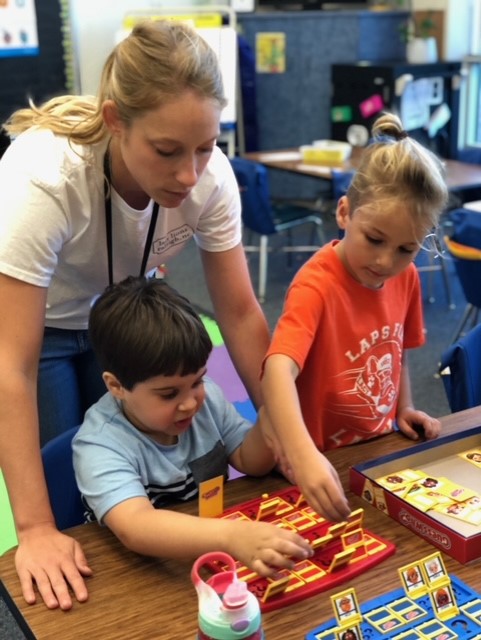 Teacher playing a game with 2 students