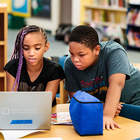 two students looking at a computer