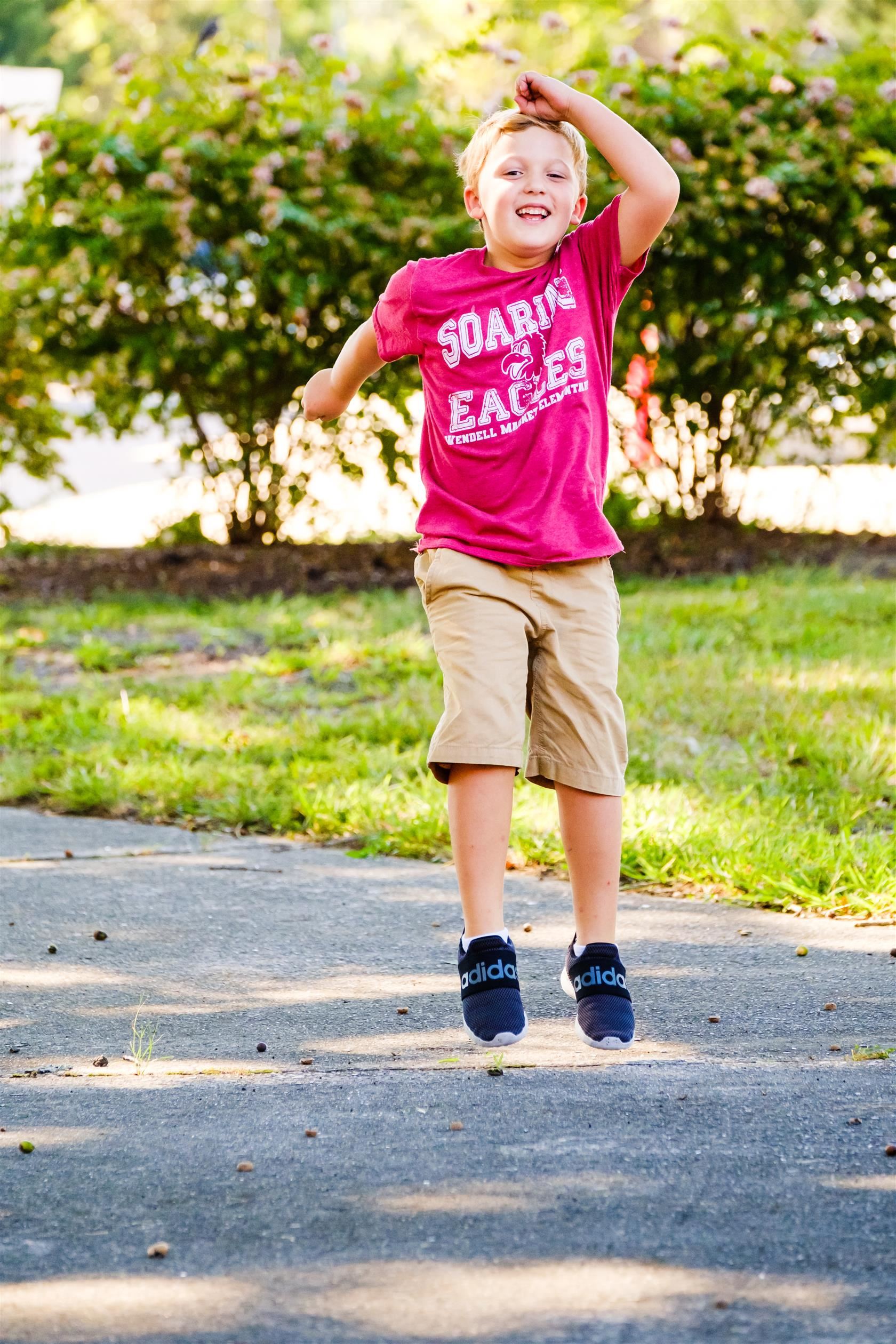  Boy jumping in red shirt. 