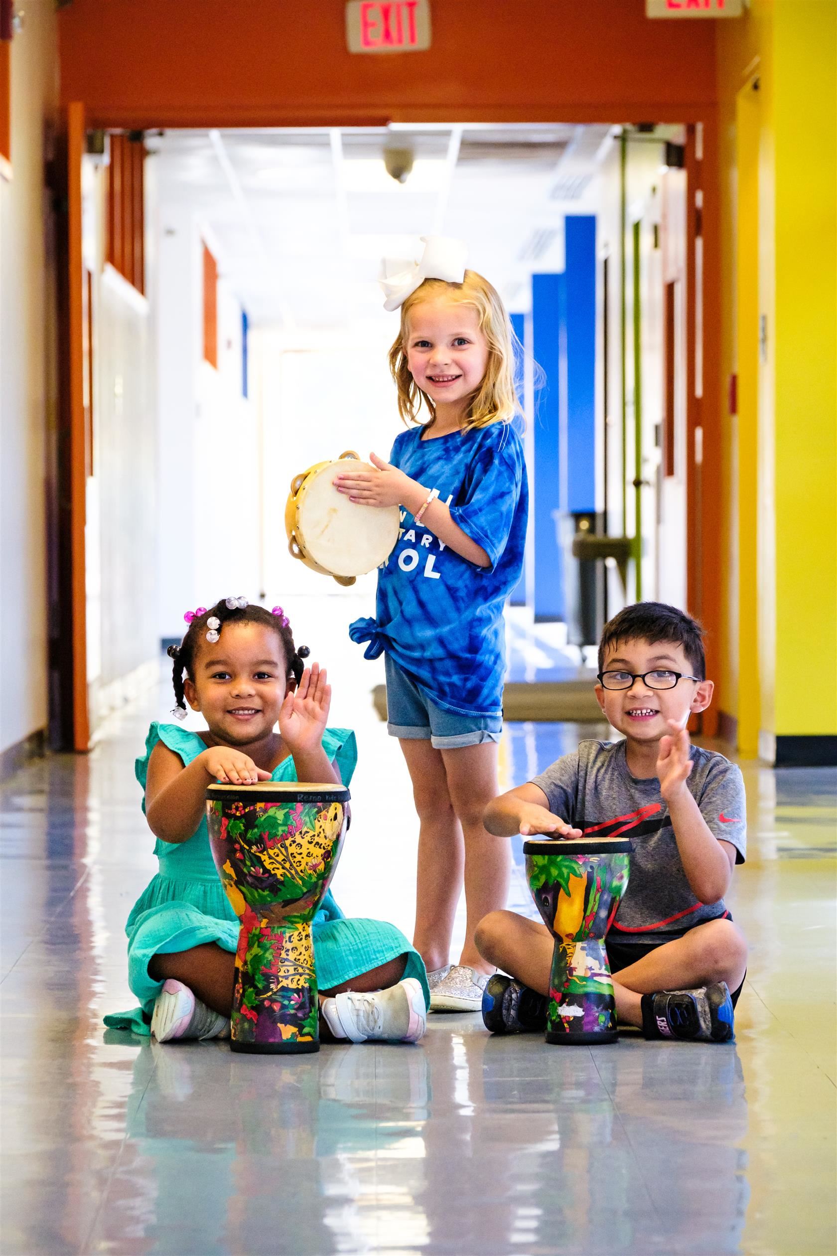  girl, girl, and boy with instruments 