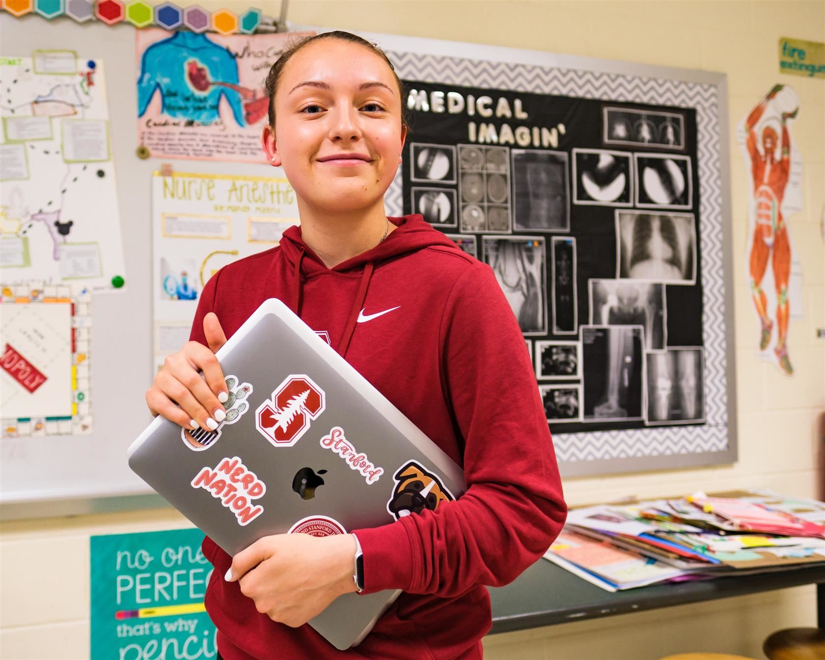 ava jeffs holding a laptop