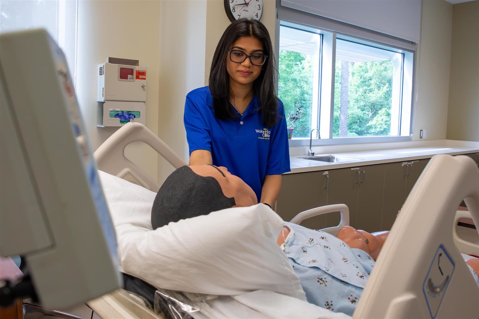 Anya practices on a training mannequin