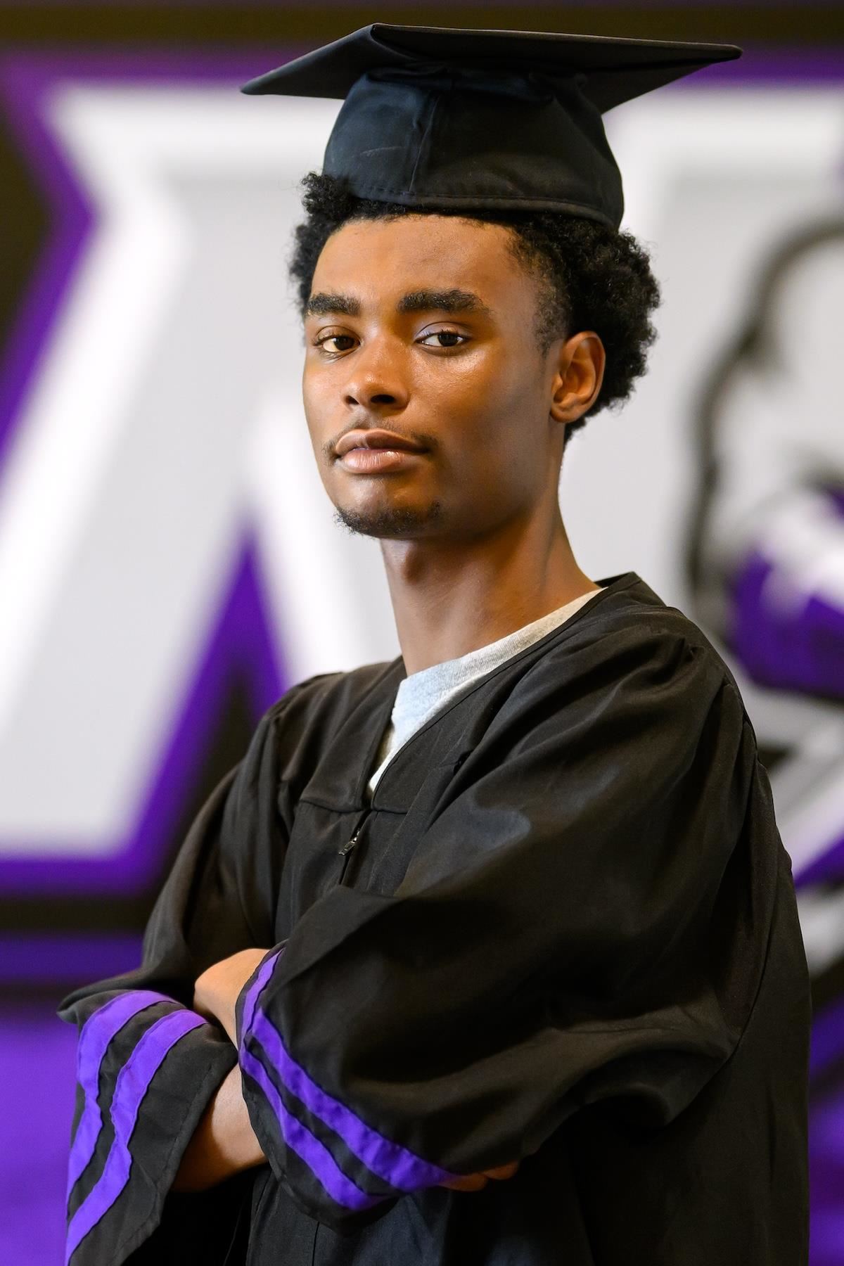 Naisuan Wilkins poses in his graduation cap and gown