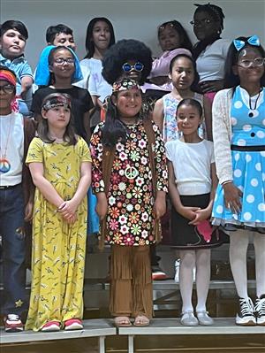 Students standing on stage during chorus concert