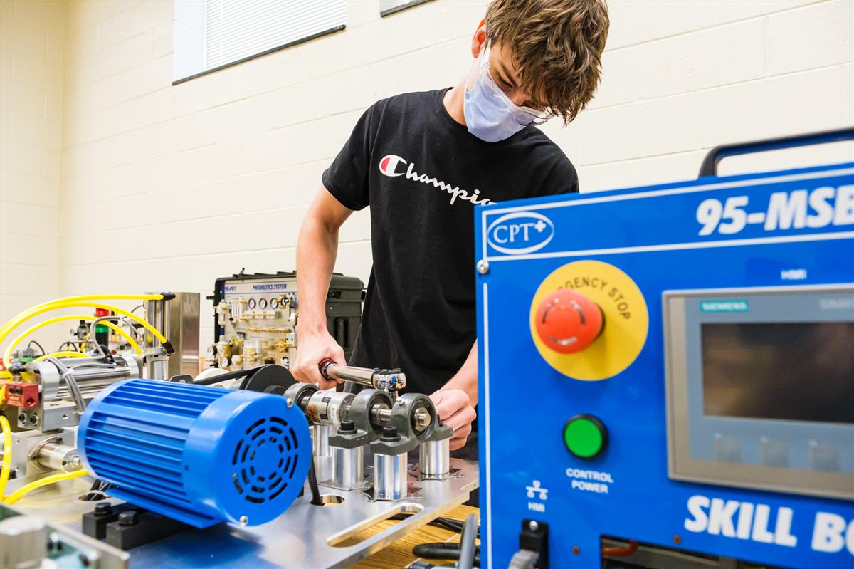 ATAM student doing a maintenance procedure in the Advanced Manufacturing lab