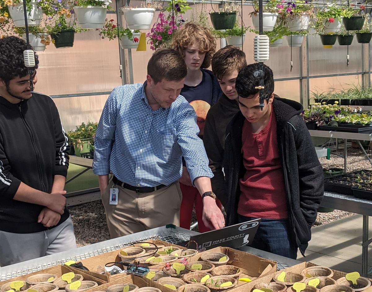 ATAM students taking measurement to gather plant data