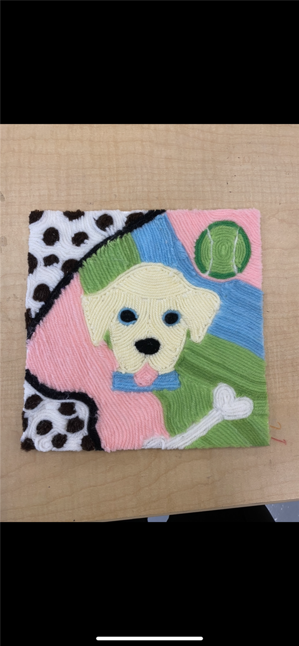 A yarn artwork of a peppy, tennis ball, and bone. 