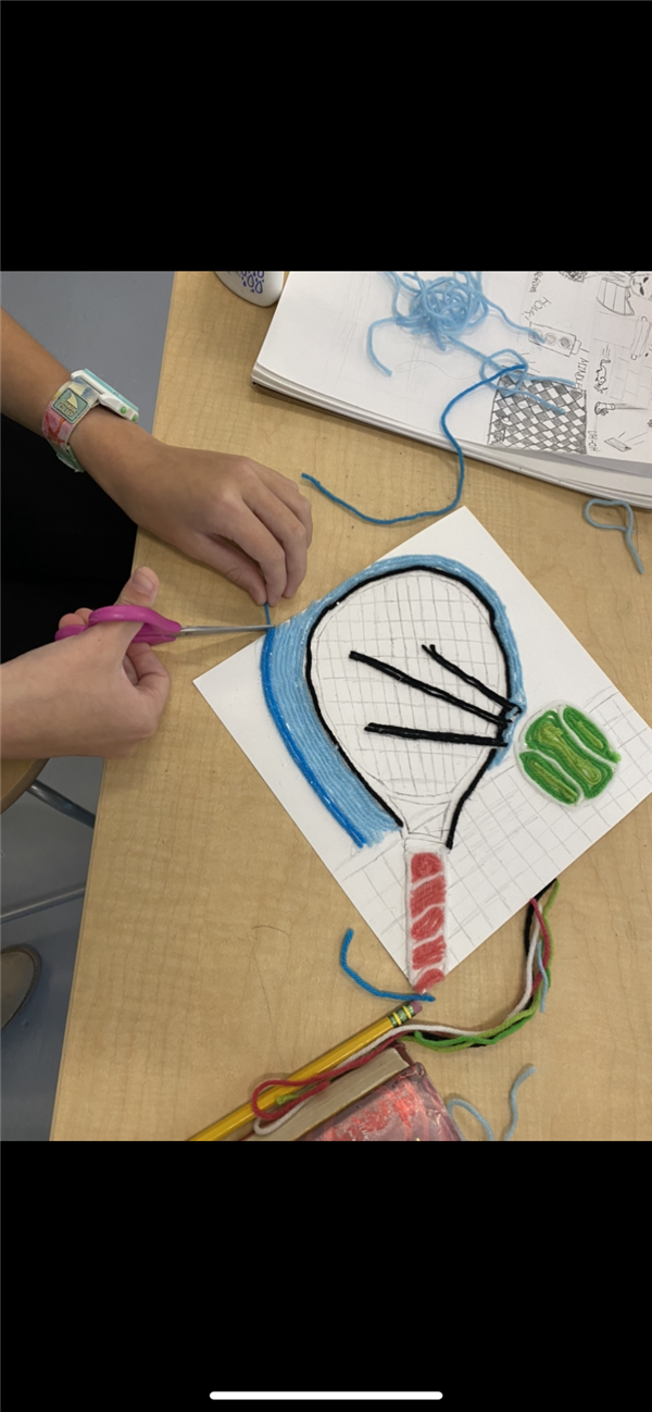 Students use yarn to create pictures. 